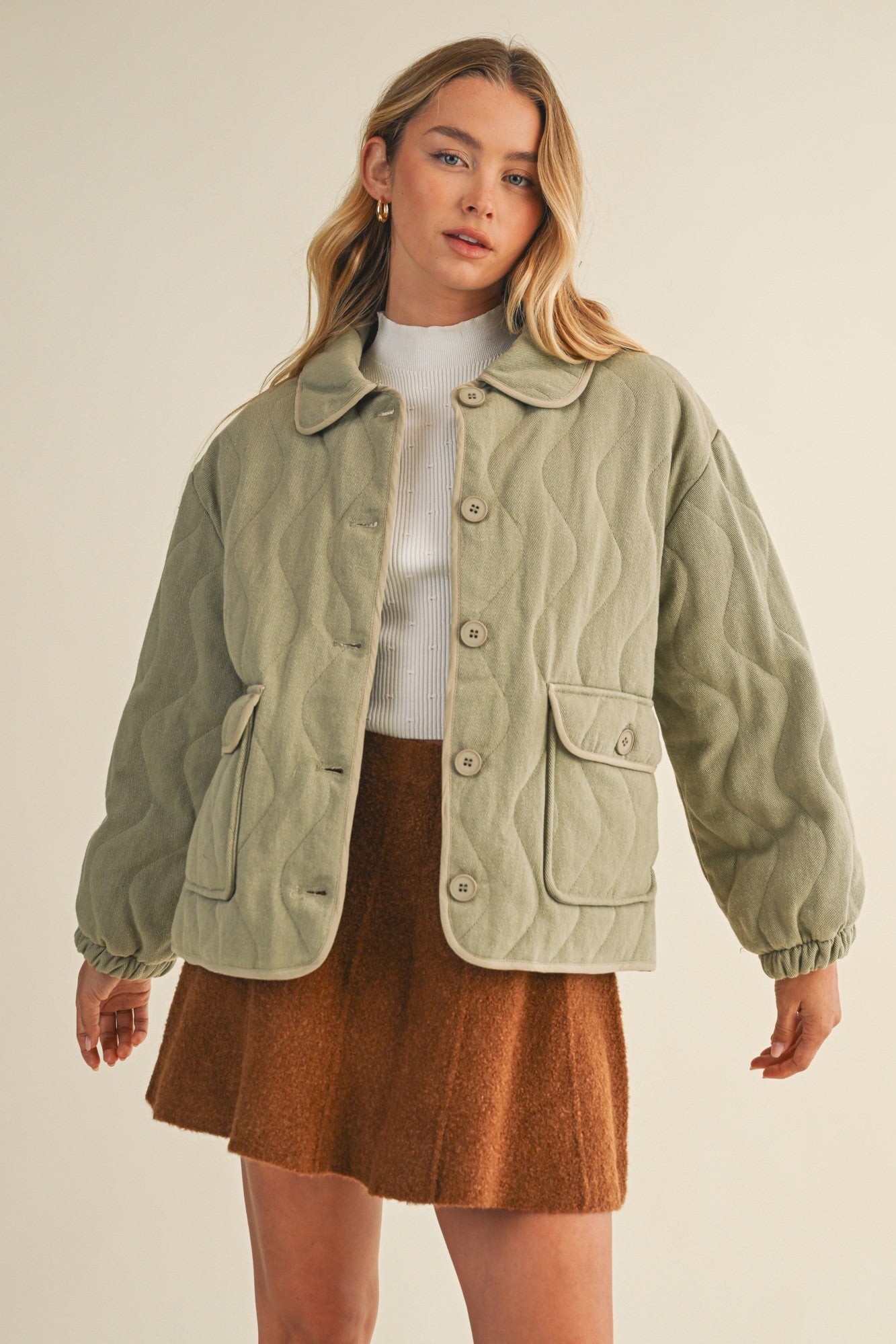 Front portrait of model wearing the Magnolia Wave Quilted Cotton Jacket in olive