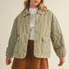 Front portrait of model wearing the Magnolia Wave Quilted Cotton Jacket in olive