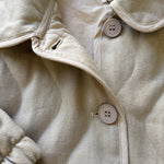 Close-up detail of pocket and stitching on the wheat quilted cotton jacket