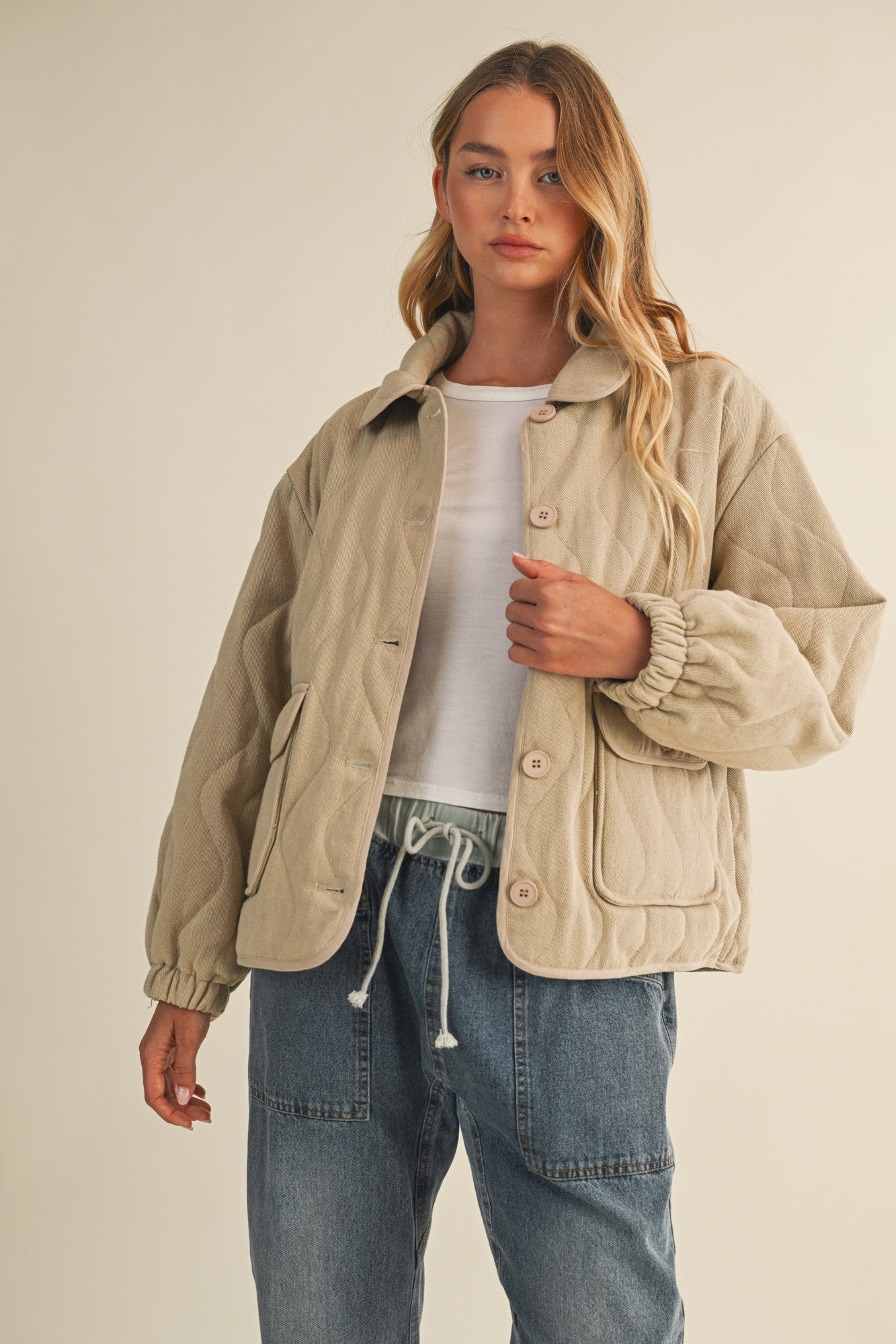 Front portrait of model wearing the Magnolia Wave Quilted Cotton Jacket in wheat