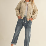 Full-body front view of the Magnolia Wave Quilted Cotton Jacket in wheat styled with jeans