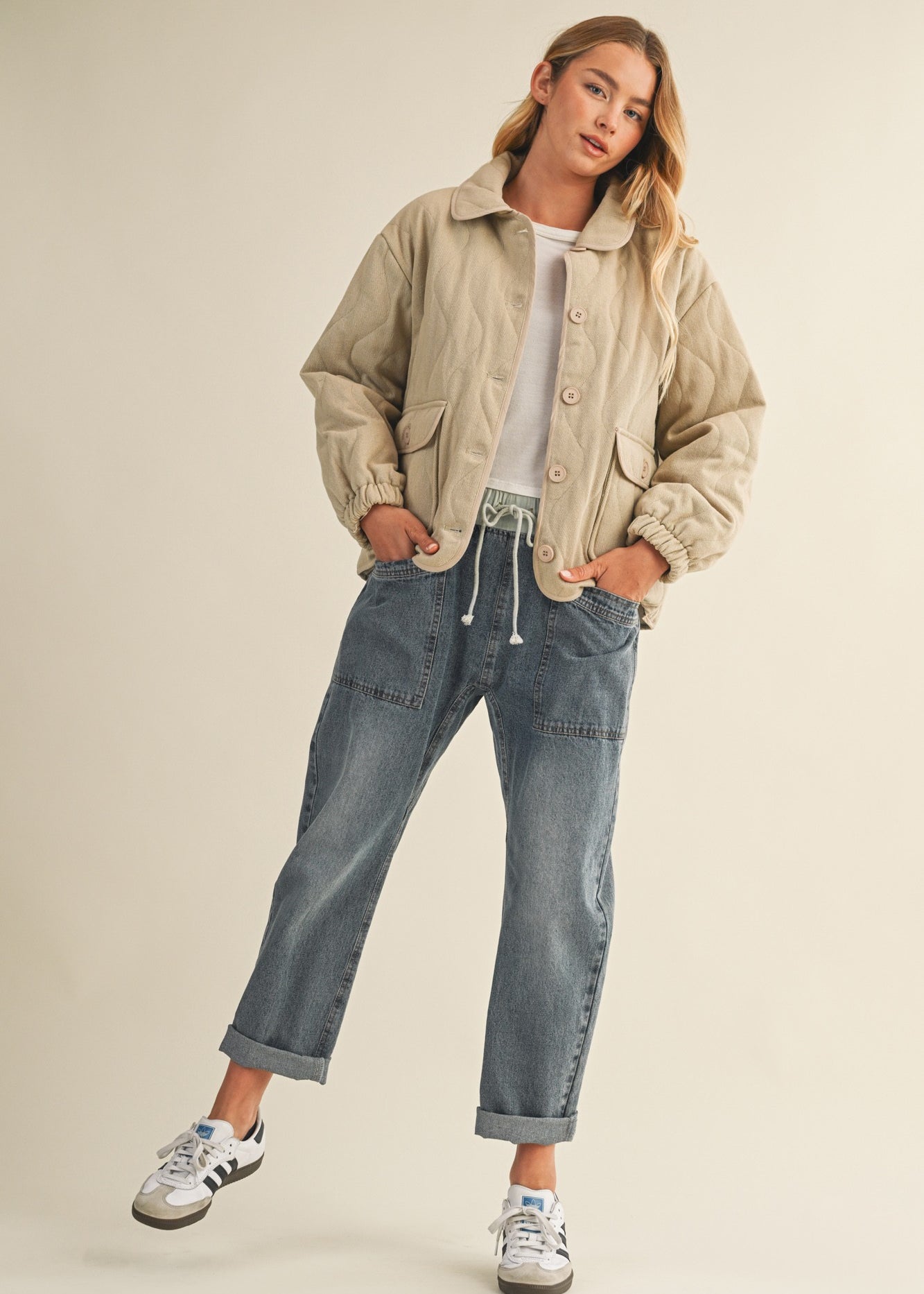 Full-body front view of the Magnolia Wave Quilted Cotton Jacket in wheat styled with jeans