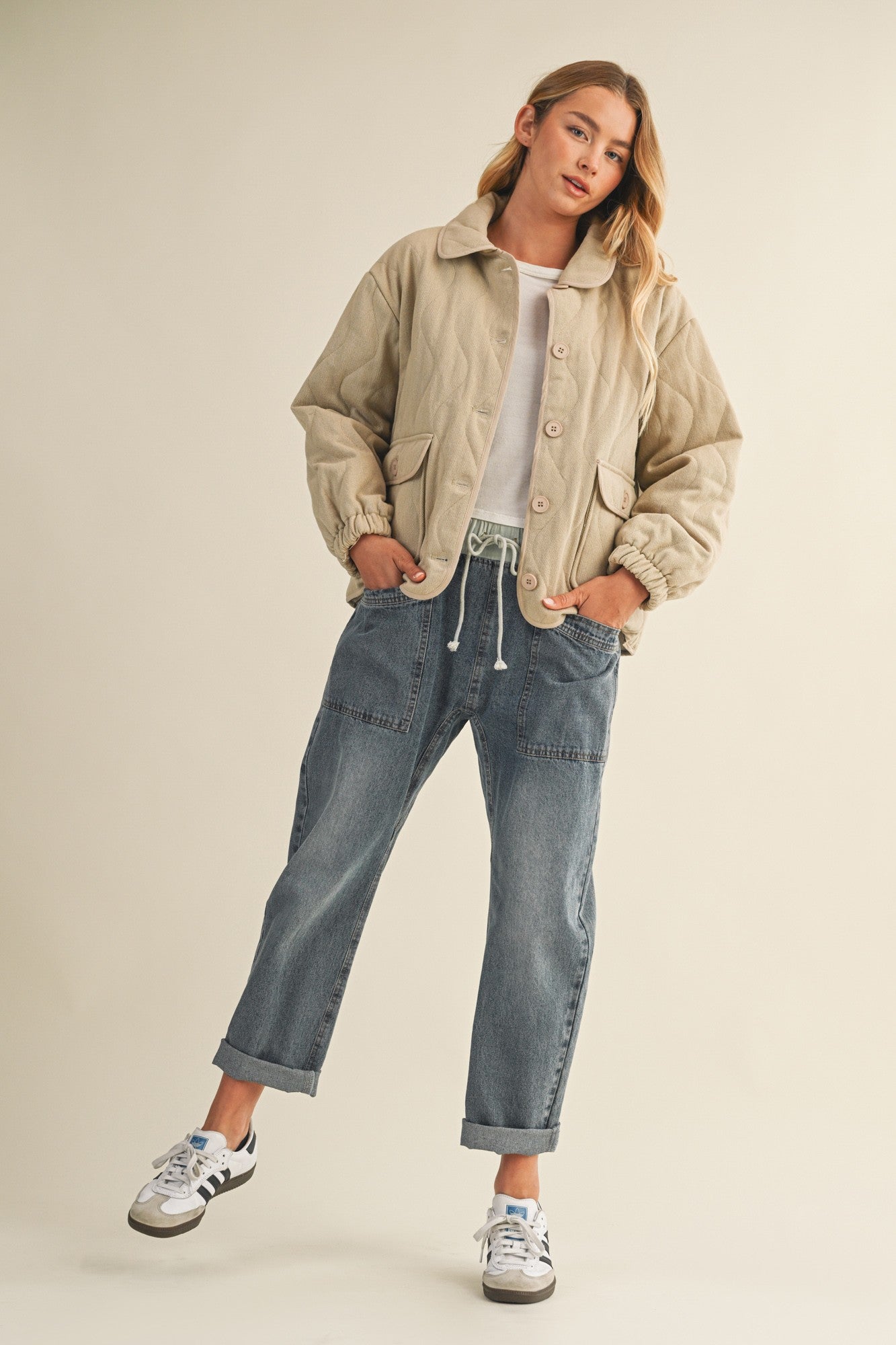 Full-body front view of the Magnolia Wave Quilted Cotton Jacket in wheat styled with jeans