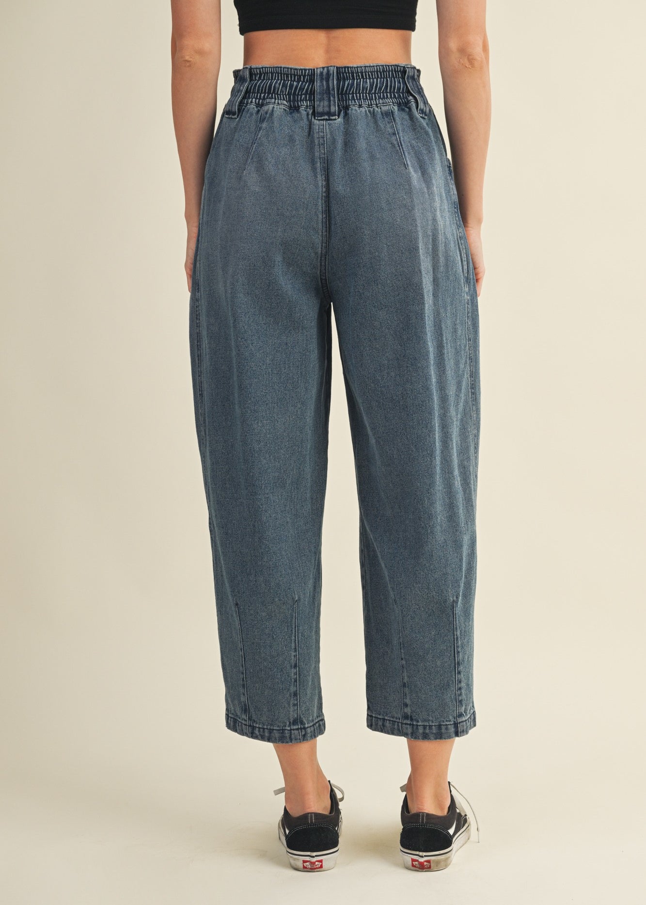 Back view of Margo pleated pull-on denim pants in washed denim