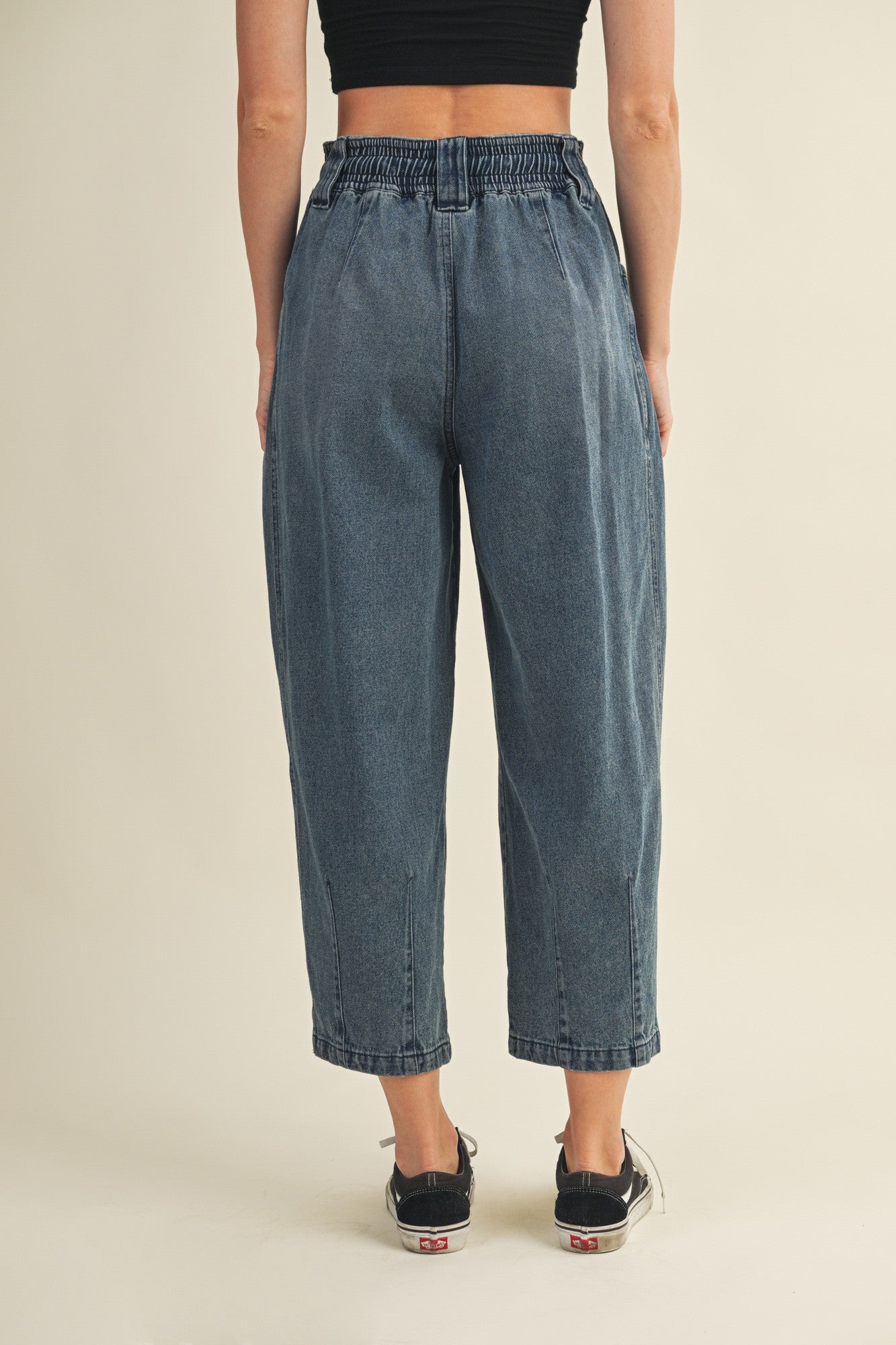 Back view of Margo pleated pull-on denim pants in washed denim