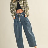 model s wearing margo pleated pull-on denim pants styled with jacket and sneakers