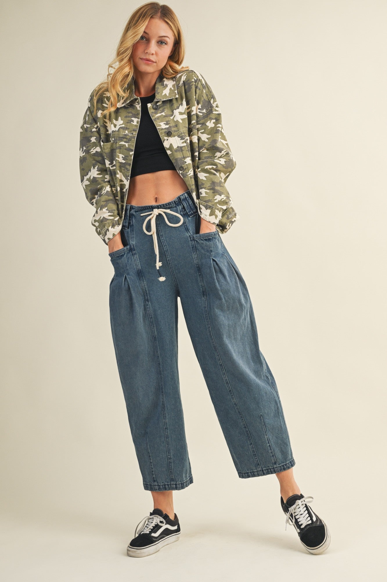 model s wearing margo pleated pull-on denim pants styled with jacket and sneakers