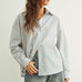 Person wearing a Marina relaxed fit shirt and wide-leg jeans against a plain background