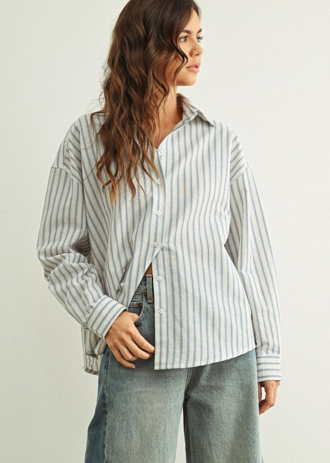 Person wearing a Marina relaxed fit shirt and wide-leg jeans against a plain background