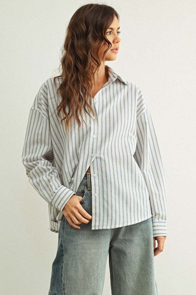 Person wearing a Marina relaxed fit shirt and wide-leg jeans against a plain background