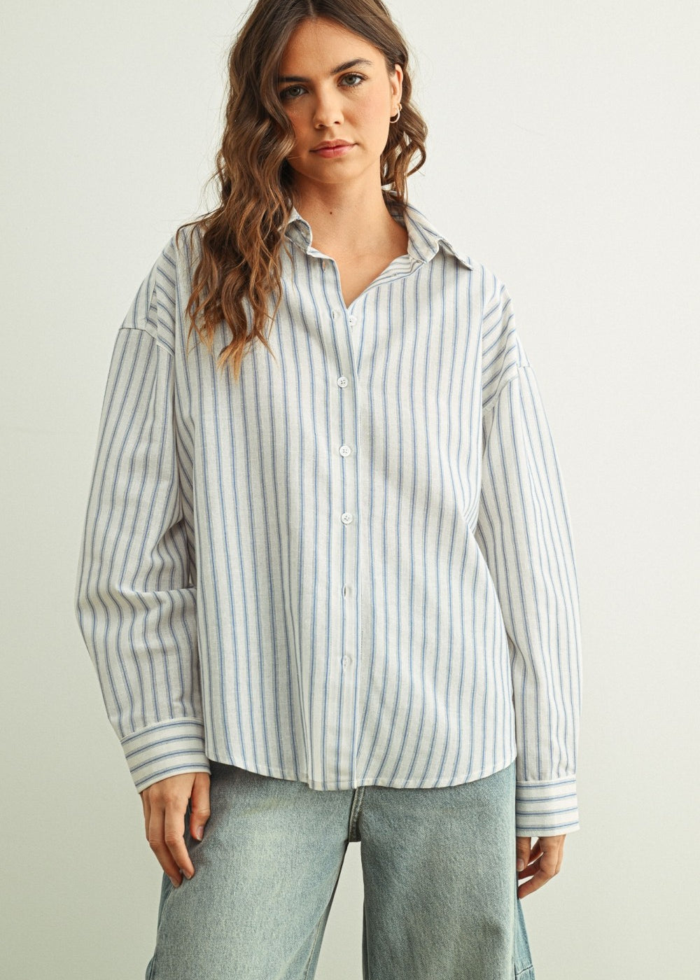 Marina blue striped button-down shirt with relaxed fit and dropped shoulders front