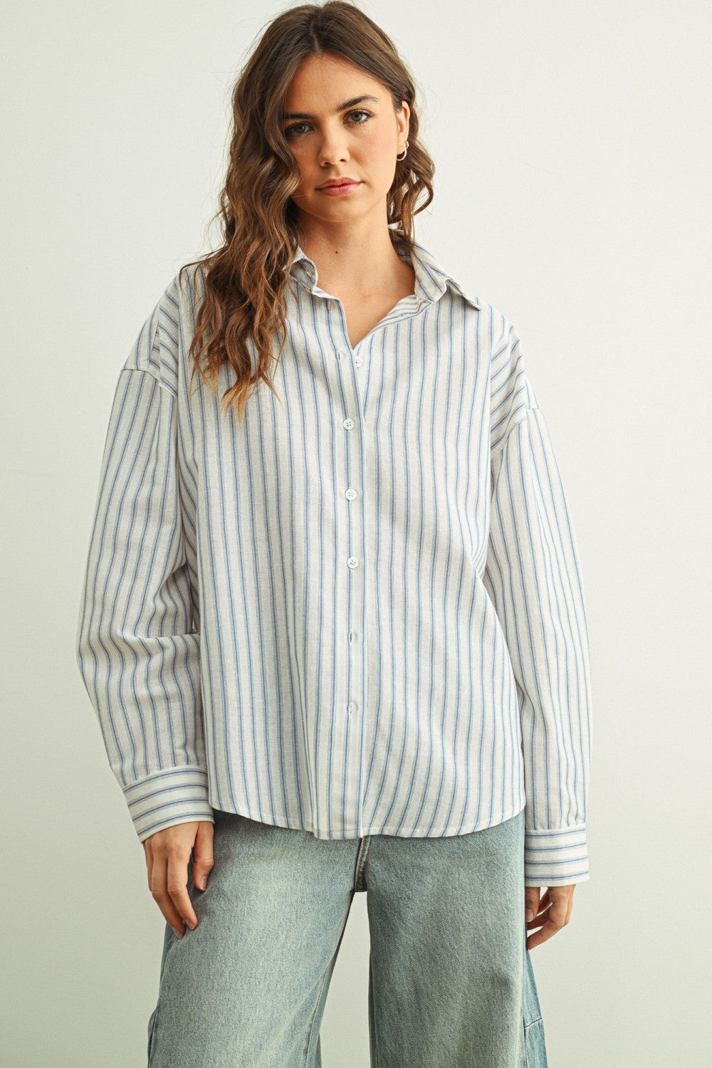 Marina blue striped button-down shirt with relaxed fit and dropped shoulders front