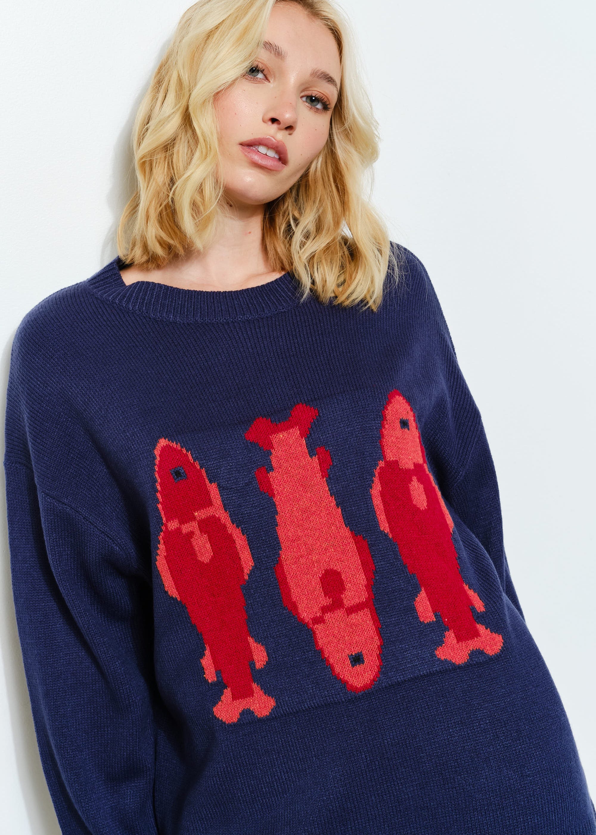Side view of the Marina Fish Knit Sweater in navy — cozy oversized fit with soft textured knit fabric- sardine print