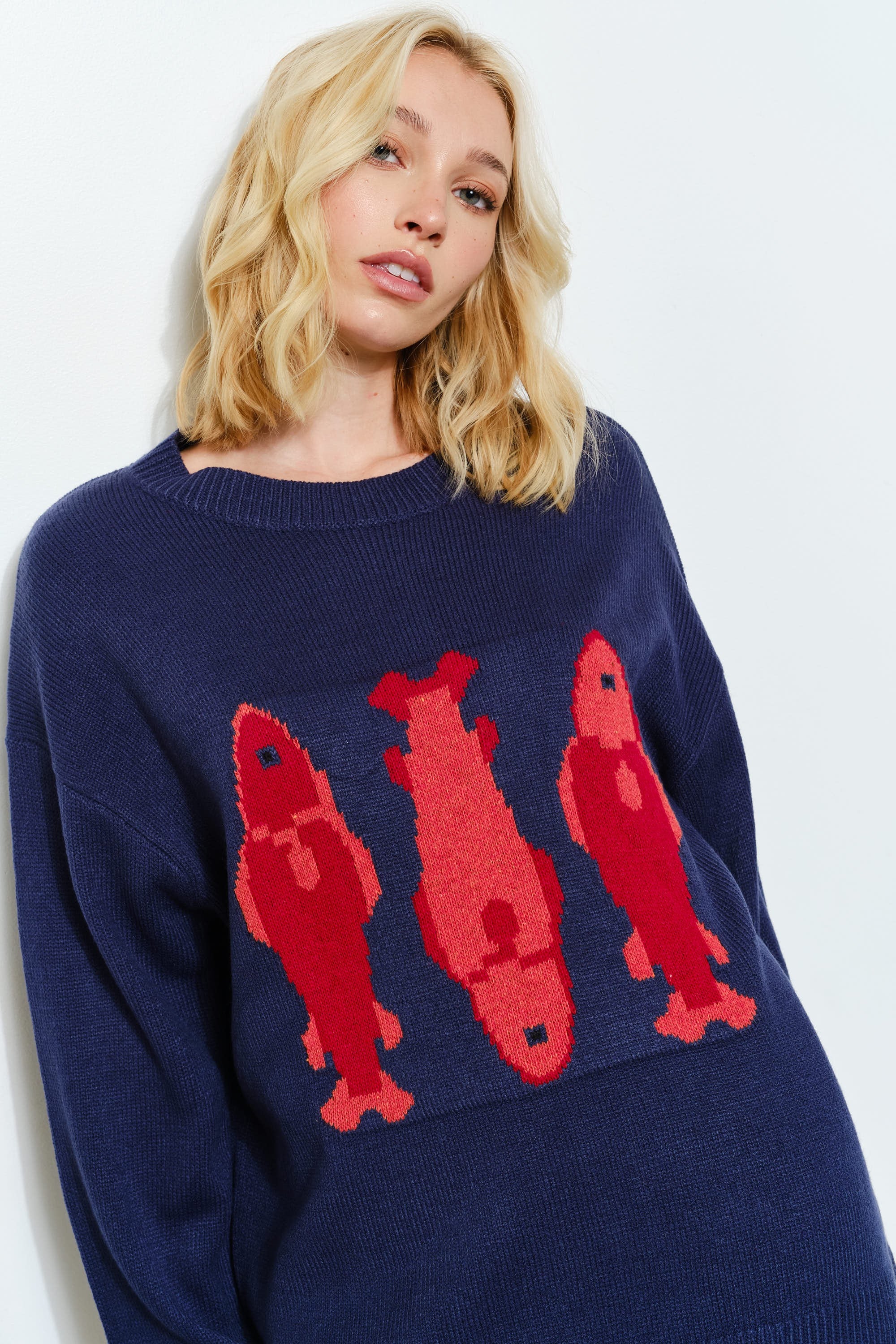 Side view of the Marina Fish Knit Sweater in navy — cozy oversized fit with soft textured knit fabric- sardine print
