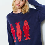 Woman is wearing  the Marina Fish Knit Sweater in navy — cozy and cute oversized fit sweater. 