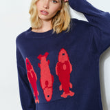 Woman is wearing  the Marina Fish Knit Sweater in navy — cozy and cute oversized fit sweater. 
