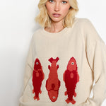Woman wearing the Marina Fish Knit Sweater in sand - cute beige pullover with print
