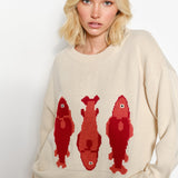 Woman wearing the Marina Fish Knit Sweater in sand - cute beige pullover with print