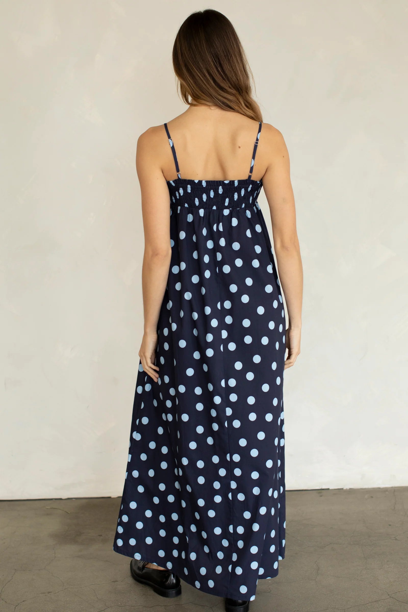 Back view of Marty Relaxed Maxi Dress in Midnight Polka Dot with stretchy smocked bodice