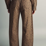 Back view of Miou Muse cocoa-brown polka dot barrel jeans showing back pockets and relaxed legs