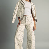 Model wearing MIOU MUSE ecru and black polka dot jacket with matching barrel jeans and red flats