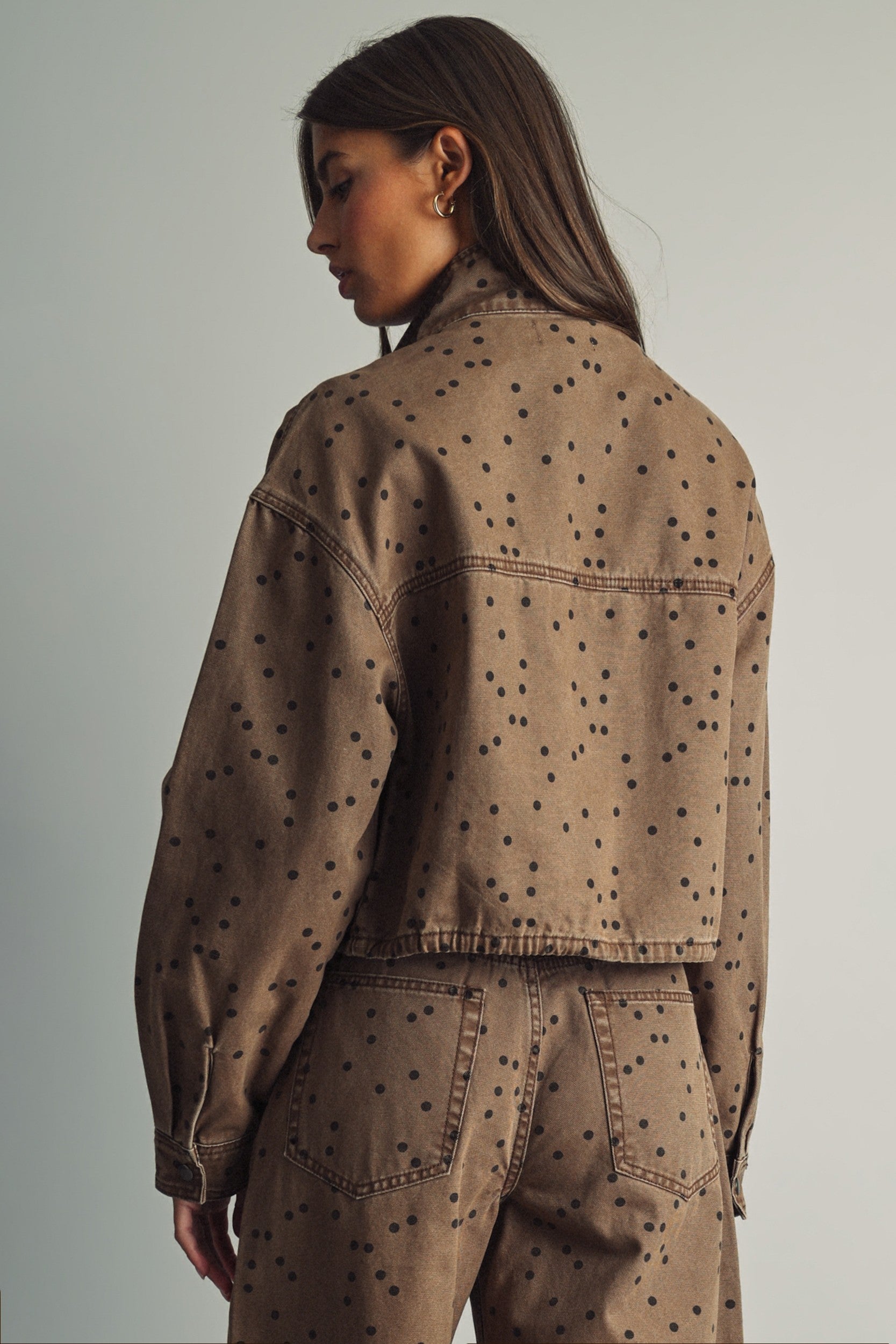 Back view of Miou Muse cocoa and black polka dot jacket showing its relaxed, boxy fit