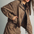 Front view of model wearing Miou Muse cocoa-brown jacket with black polka dots and a funnel neck