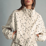 Front view of MIOU MUSE ecru jacket with black polka dots, a funnel neck, and a cropped boxy fit