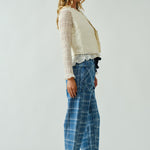 Model is wearing Moxie Jeans. Side view of the blue plaid barrel jeans highlighting relaxed silhouette