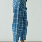 Side walking view of the barrel-leg jeans showing movement and drape