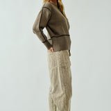 Woman wearing Moxie Barrel Eyelet Jeans in corduroy dove with cozy sweater — effortless casual outfit for everyday wear.