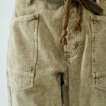 Close-up of Moxie Barrel Eyelet Jeans waist detail — eyelet design with corded drawstrings and soft corduroy texture.