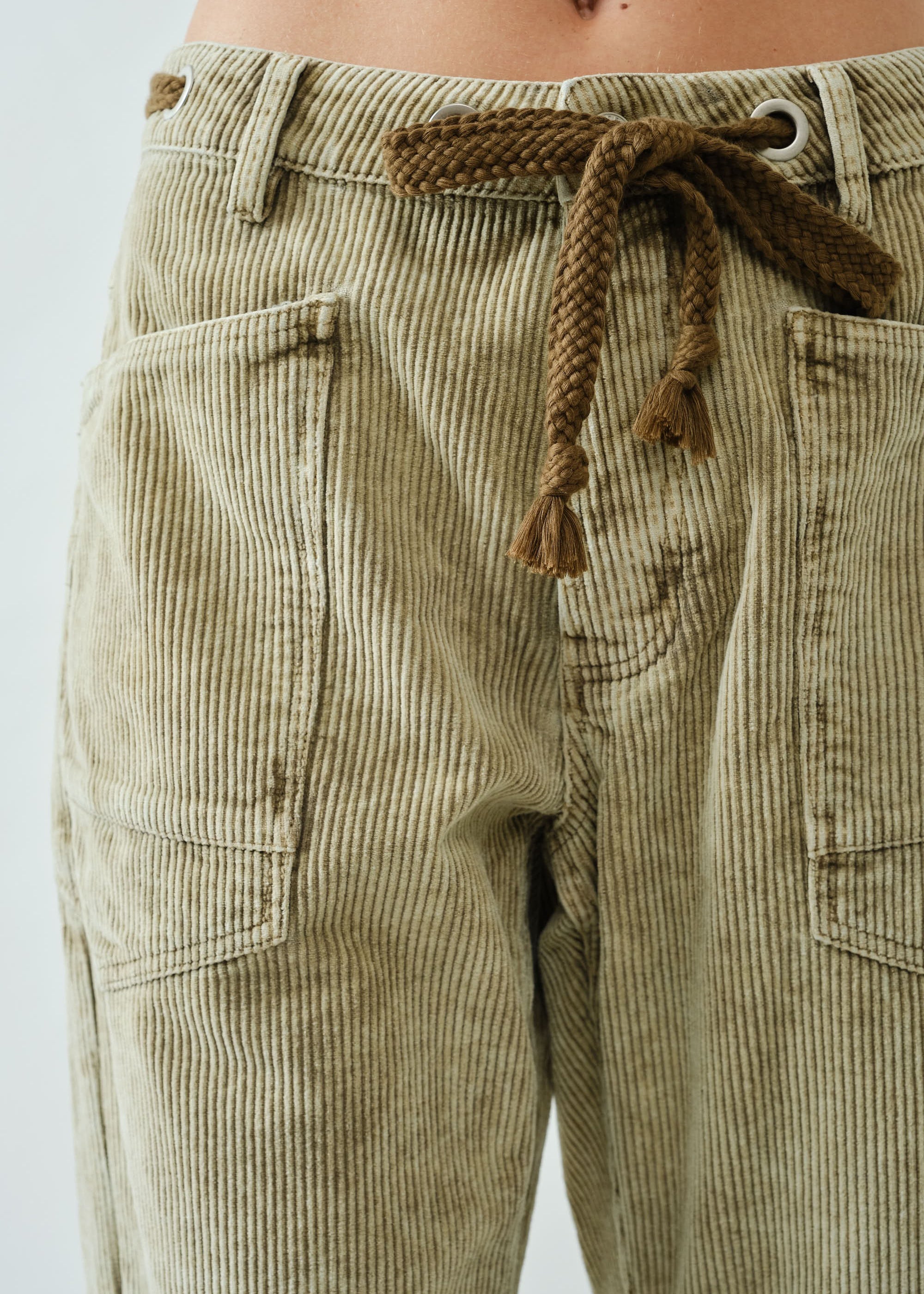Close-up of Moxie Barrel Eyelet Jeans waist detail — eyelet design with corded drawstrings and soft corduroy texture.
