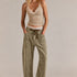 Woman wearing the Moxie Corduroy Barrel Jeans in Olive — relaxed barrel silhouette with drawstring waist.