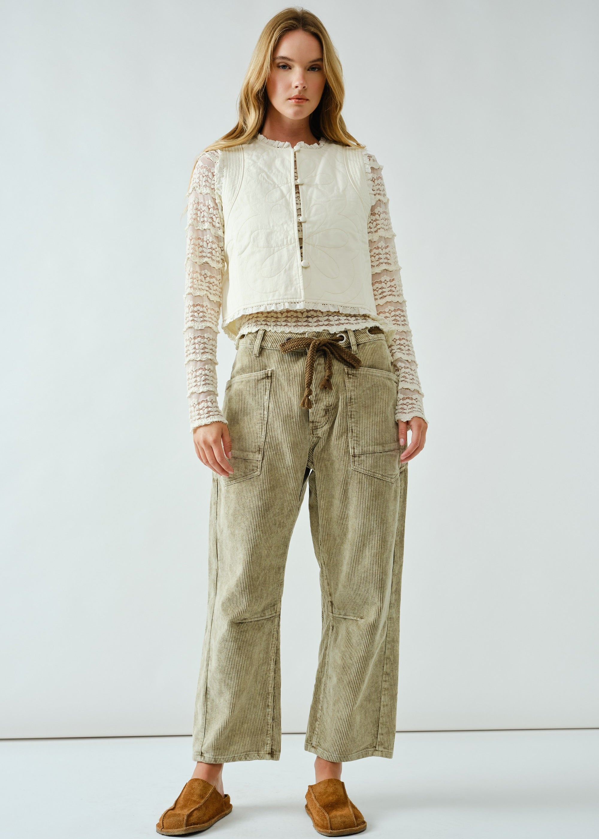 Woman wearing the Moxie Barrel Eyelet Jeans in corduroy olive — relaxed barrel silhouette with drawstring waist.