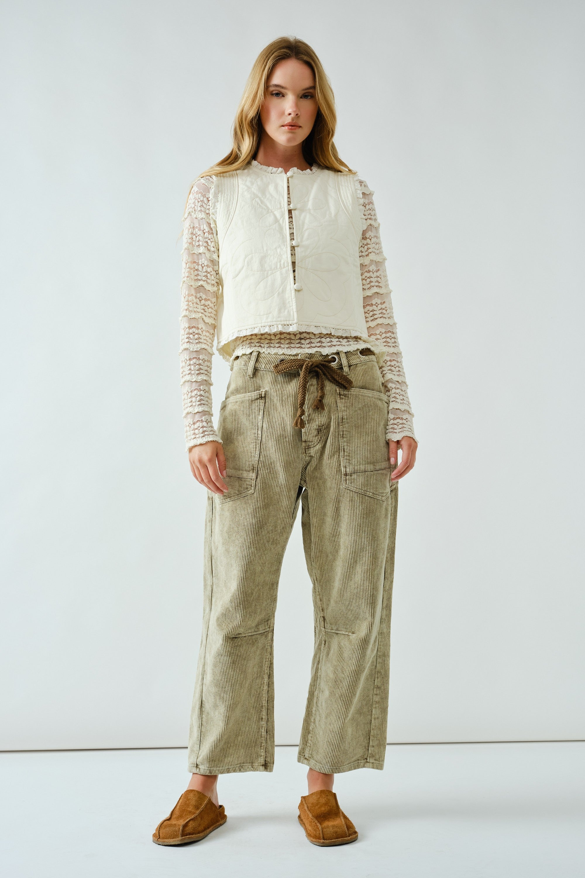 Woman wearing the Moxie Barrel Eyelet Jeans in corduroy olive — relaxed barrel silhouette with drawstring waist.