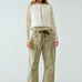 Woman wearing the Moxie Barrel Eyelet Jeans in corduroy olive — relaxed barrel silhouette with drawstring waist.