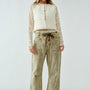 Woman wearing the Moxie Corduroy Barrel Jeans in Olive — relaxed barrel silhouette with drawstring waist.