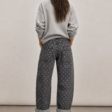 Back view of Moxie Barrel Eyelet Jeans in Polka Dot Black with all-over white polka dot print and relaxed barrel fit.
