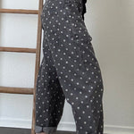 Close-up side detail of Moxie Barrel Eyelet Jeans in Polka Dot Black showing the relaxed barrel shape, pocket detail, and white dot print.