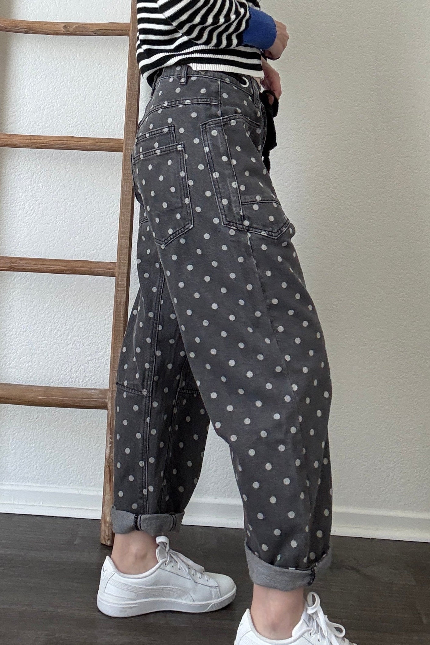 Close-up side detail of Moxie Barrel Eyelet Jeans in Polka Dot Black showing the relaxed barrel shape, pocket detail, and white dot print.