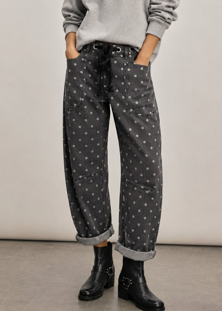 Model wearing Moxie Polka Dot Barrel Jeans in Black with a gray sweater and black boots