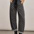 Model wearing Moxie Polka Dot Barrel Jeans in Black with a gray sweater and black boots
