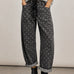 Model wearing Moxie Polka Dot Barrel Jeans in Black with a gray sweater and black boots