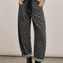 Model wearing Moxie Polka Dot Barrel Jeans in Black with a gray sweater and black boots