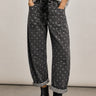 Model wearing Moxie Polka Dot Barrel Jeans in Black with a gray sweater and black boots
