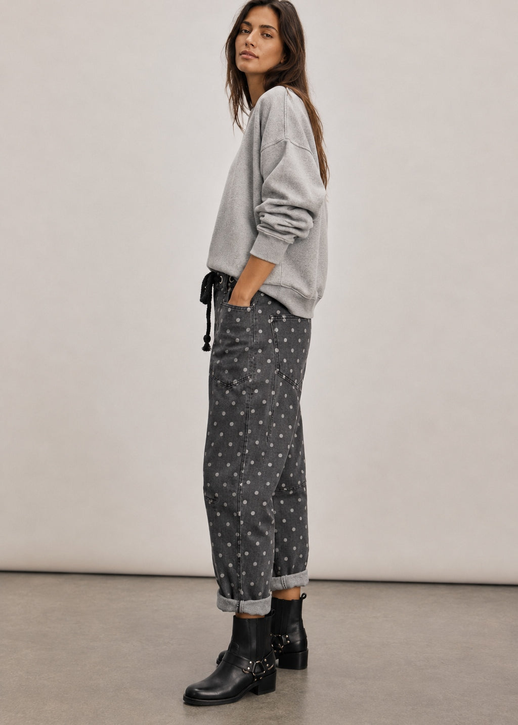 Side view of Moxie Polka Dot Barrel Jeans in Black showing the curved leg shape