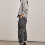 Side view of Moxie Barrel Eyelet Jeans in Polka Dot Black with a cropped barrel-leg fit and slouchy relaxed shape.