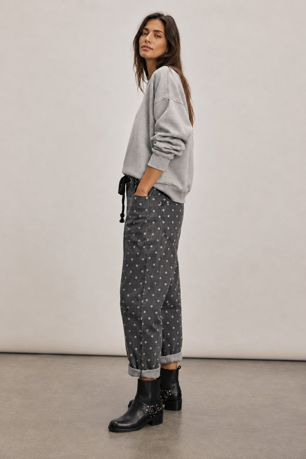 Side view of Moxie Barrel Eyelet Jeans in Polka Dot Black with a cropped barrel-leg fit and slouchy relaxed shape.