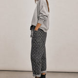 Side view of Moxie Barrel Eyelet Jeans in Polka Dot Black with a cropped barrel-leg fit and slouchy relaxed shape.